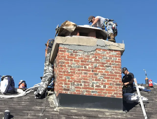 Groton Chimney Sweep installing a custom chimney crown in Groton, MA