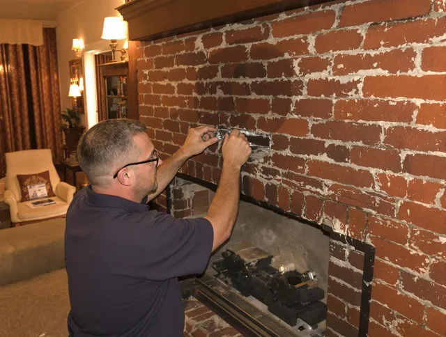 Groton Chimney Sweep expert fixing a fireplace in Groton, MA